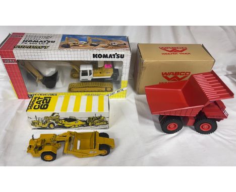 An NZG CAT 621 Schurfzug scraper, No. 121, Joal Compact Komatsu Tracked Excavator, No. 186 and a Conrad Wabco Haulpak Truck i