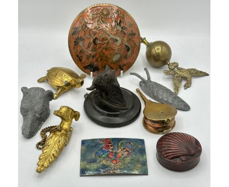 A miscellany comprising : two enamel plaques, one depicting a cockerel the other a lid without a base, a lead dog's head and 