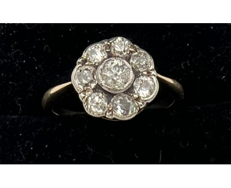 A diamond cluster ring set in unmarked yellow metal. Size J/K. Weight 2.3gm. 