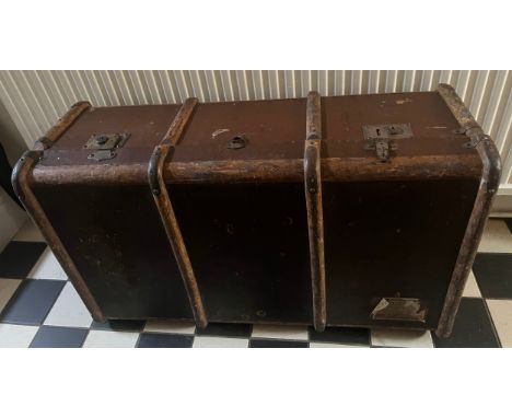 A vintage wooden bound trunk. Approximate size 91cm l x 54cm w x 32cm h. Together with some vintage fur stoles. 