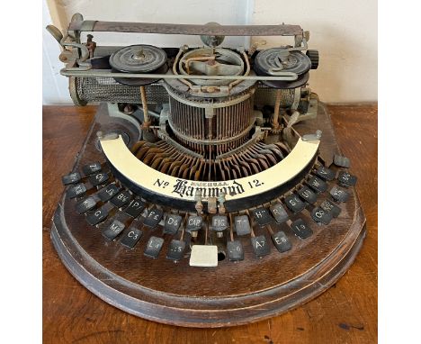 An American Hammond no. 12 typewriter on oak base. Approximately 38cm w. 