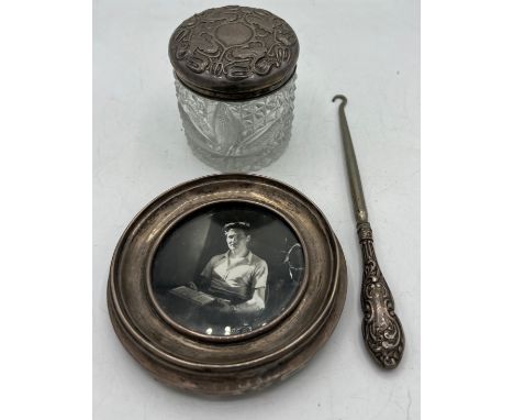 Silver circular photograph frame, glass pot with Art Nouveau silver top and a button hook, various dates and makers. 