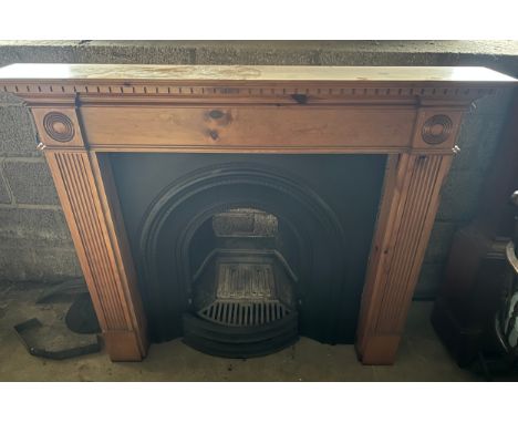 A cast iron fireplace insert with pine surround. 138cm w x 20.5cm d x 110cm h. 