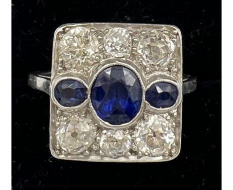 A diamond and sapphire square shaped ring set in platinum. Six old cut diamonds 4 x 0.25 carat, 2 x 0.10 carat. Total 1.20 ca