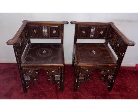 A pair of carved hardwood corner chairs with mother of pearl inlay. Height to back 75cm. 