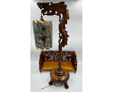 A Chinese carved wooden Dragon lamp and shade with a carved wooden folding bookstand. 