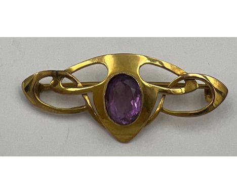 A 9 carat gold brooch set with amethyst. 4.5cm l. Weight 3.6gm. 