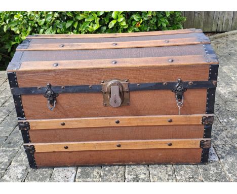 A vintage wood and metal bound trunk. 53cm h x 76cm w x 45cm d 