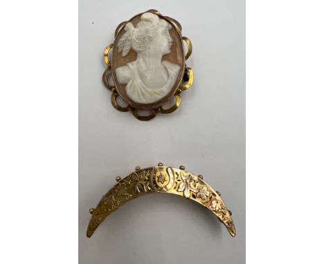A 9 carat gold crescent brooch together with a carved shell cameo brooch in a 9 carat gold surround. 3.5cm x 3cm. Total weigh