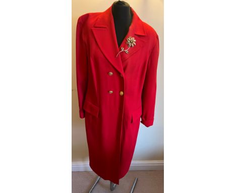 A Givenchy en plus vintage dress with gilt buttons and attached gilt flower brooch. Marked size F44. One spare button to insi
