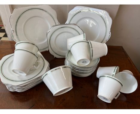 An Art Deco Osborne bone china tea-service comprising 12 tea plates, 12 saucers, 2 bead and butter plates, 8 cups and a sugar