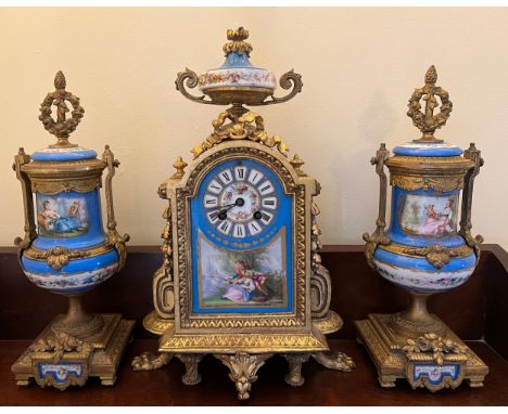 A French gilt metal mantle clock with a painted porcelain face, case back stamped  P.H. Mourey 74, height 40cm h together wit