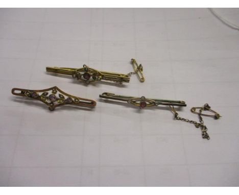 Three Edwardian bar brooches to include one inset with amethyst and seed pearls 