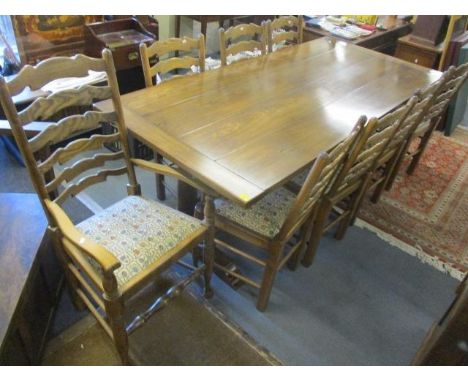 A large reproduction English oak refectory dining table, 29 1/2" h x 81 1/2"w and a set of eight matching ladder back chairs 