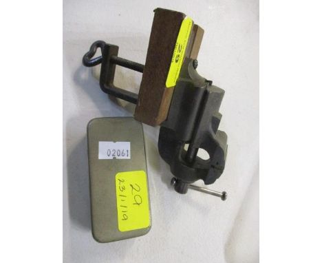 A small bench vice, together with a re-usable syringe 