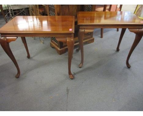 A pair of reproduction mahogany lamp tables with dual candle slides on cabriole legs 