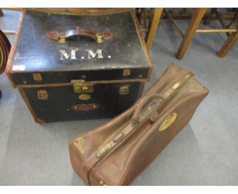 A Victorian black canvas and brown leather trunk, along with a brown leather Gladstone bag 