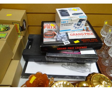 Mixed parcel of items including hand weights, boxed wall clock, Grand Prix Legends DVD & book etc