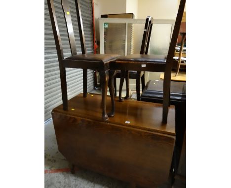 A vintage drop leaf oak dining table together with three splat back dining chairs with drop-in seats