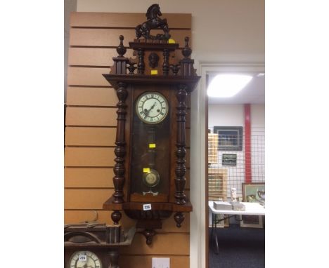 A vintage mahogany veneered Roman numeral faced Vienna wall clock