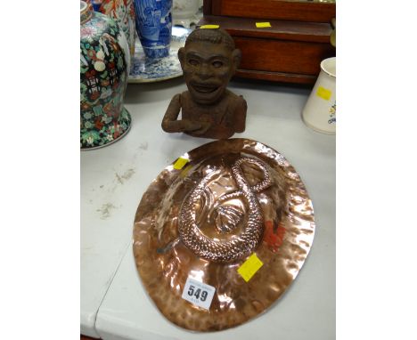 A copper snake decorated mould together with a vintage African boy money box