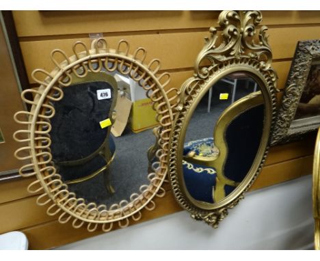 A vintage oval bamboo framed mirror together with another oval ornate gilt framed mirror