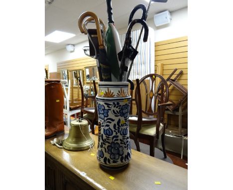 A continental ceramic stick / umbrella stand & contents including shooting stick, walking sticks etc