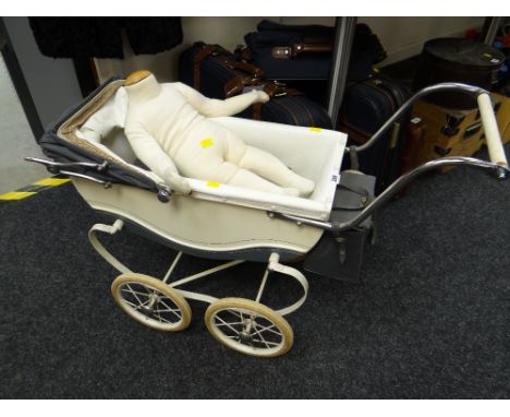 A vintage Restmor child's sprung pram together with a child mannequin
