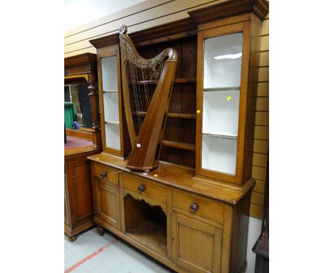 Early twentieth century light oak dresser with central shelving flanked by single glass door cupboards on a three-drawer two-