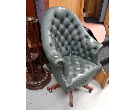 A green high button backed leather swivel desk chair 