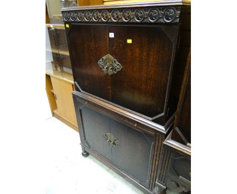 An antique reproduction dark oak cabinet with glass pull-out shelf (matching previous lot)