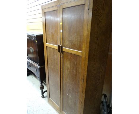 A vintage light oak shaped front two-door wardrobe