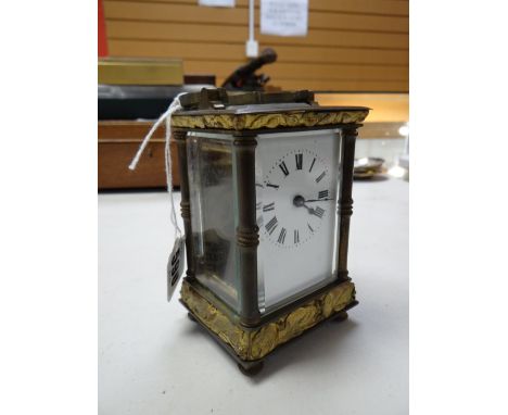 Brass mantel clock with Roman numeral face