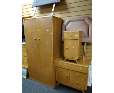 A vintage light oak bedroom suite comprising two-door wardrobe, bedside cabinet, small chest, pair of single headboards plus 