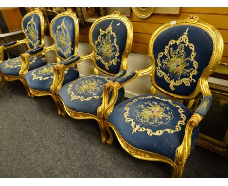 A modern reproduction French salon gilt & upholstered suite comprising four armchairs & a sofa with side tables