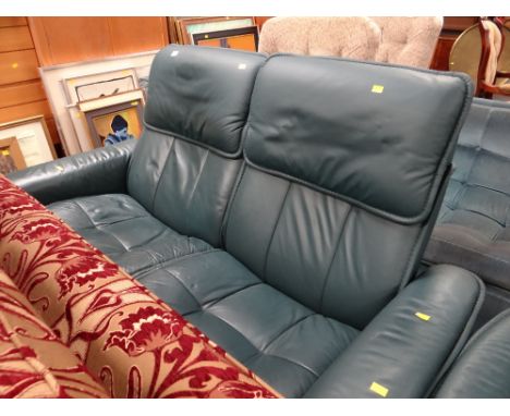 A modern turquoise leather two-seater sofa together with a matching rocking arm chair