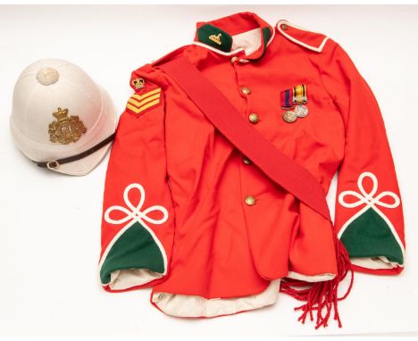 A replica Zulu war tunic of the 24th Foot, complete with medals and sash, also a white foreign service helmet, with badge. VG
