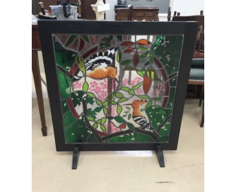 A framed firescreen with painted glass leaded picture of two hoopoes