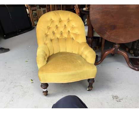 Victorian nursing chair with buttoned back golden velvet upholstery on turned legs with ceramic castors, 74cm in overall heig