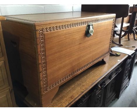 Camphor wood trunk with bands of carved floral decoration, measuring 101cm in length, 56cm in height and 50cm in depth