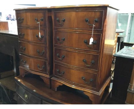 Pair of reproduction Georgian style walnut serpentine fronted bedside chests with four draws, on bracket feet, each 47cm x 76