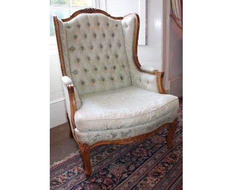 UPHOLSTERED WING BACKED ARMCHAIR WITH CARVED CABRIOLE LEGS AND ARMS - BUTTON BACKED