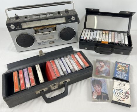 A vintage Prinz STR 1010 stereo radio cassette recorder. Together with 2 vintage cassette cases containing a collection of mu