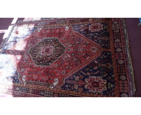 A fine South West Persian Qashqai carpet, single pole medallion on a terracotta field within stylised geometric border, 257 x