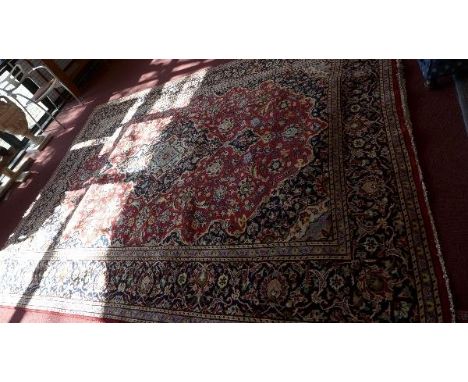 A fine Central Persian Kashan carpet, double pendent medallion on a rouge field within stylised floral border, 337 x 253cm 