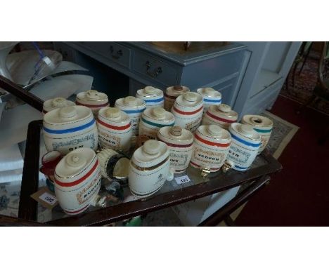 A collection of 21 Wade ceramic barrels, to include scotch, port, cognac, sherry and gin, together with 7 various Toby jugs 