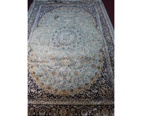 A Kashan style carpet, with central floral medallion, on a green ground, contained by floral borders, 280 x 200cm 