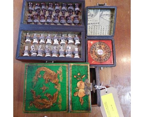 A Chinese compass in box, a Chinese travelling chess set and a Chinese vanity box 