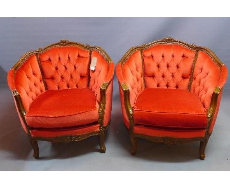 A pair of 20th century French walnut tub chairs, with button back velour upholstery, raised on cabriole legs 