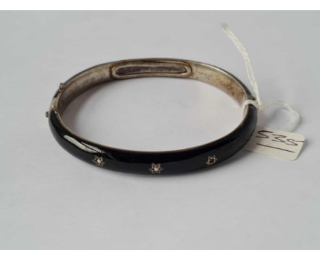 A Victorian silver and enamel bangle with hair inset 